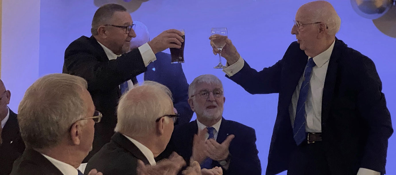 Maurice toasting the health to his predecessor and new mentor