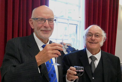 Principal guest John James (left) and Dave Kellet take wine together at the festive banquet.