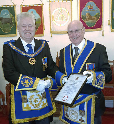 Peter Schofield (left) presents Frank Pearson with his 50th anniversary testimonial.
