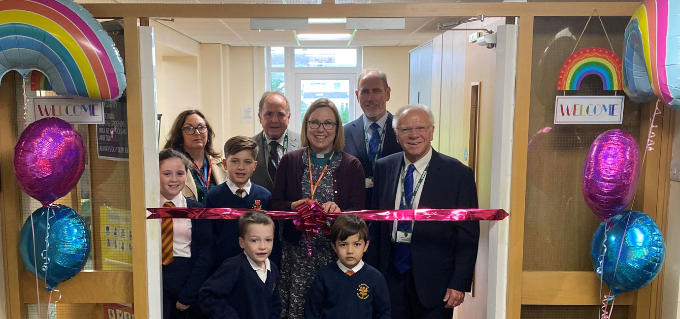 Revd Beth Anderson cutting the ribbon to officially open the St Nicholas Primary School Rainbow Room.