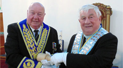 John Rawcliffe (right) has the gavel returned by Peter Levick.