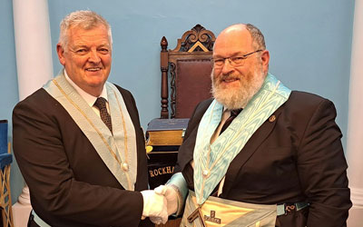 Colin Fisher (left) being congratulated by Ian Hunter. Colin Fisher (left) being congratulated by Ian Hunter.