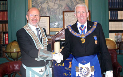 The WM Phil Osborne (left) welcomes Mark Matthews to the lodge.