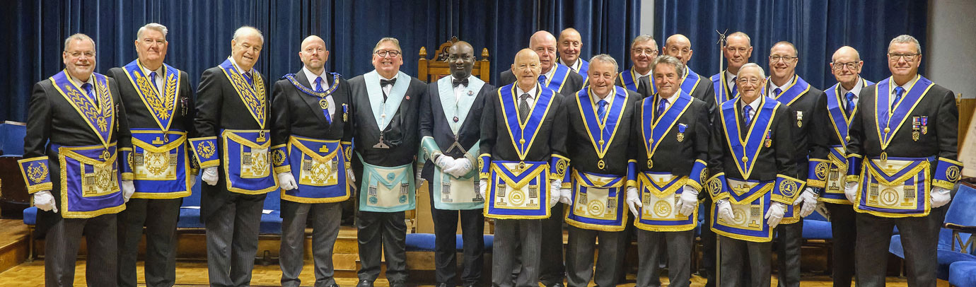 Pictured from left to right, are: Chris Eyres, Malcolm Parr, Anthony Bent, Malcolm Bell, Glyn Jones, Azeez Amosun and the group of Provincial grand officers in attendance.