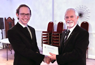 Chris Hales (left) being presented with his welcome pack by Paul Brunskill.