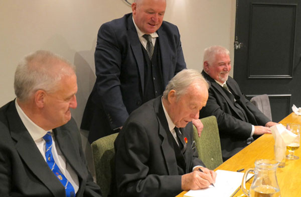 The WM signs the log The WM signs the log