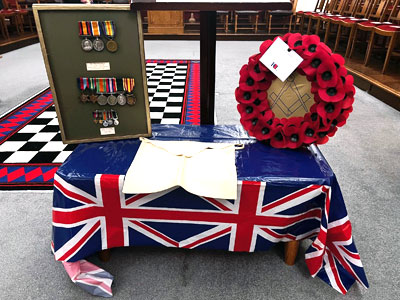 Entered apprentice apron, wreath and military medals prepared for the ceremony.