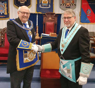 Philip Gunning (left) congratulates the new master Ian Fell.