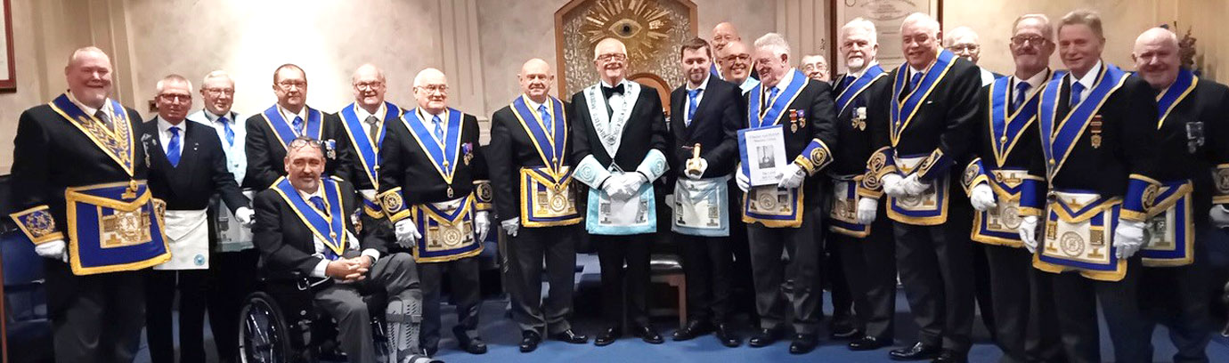 Battle for the gavel, pictured left: Peace Lodge members and winners Tyldesley Lodge (right) with their WM holding the gavel.