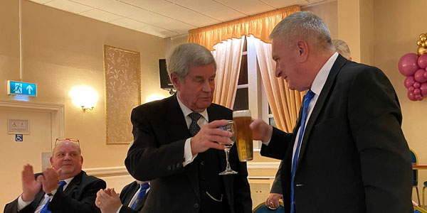 Tony Barrow (left) and Terry Cunningham toasting to each other’s health.