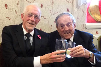 Ken Hart (left) takes wine with Peter Gratrix at the festive board.