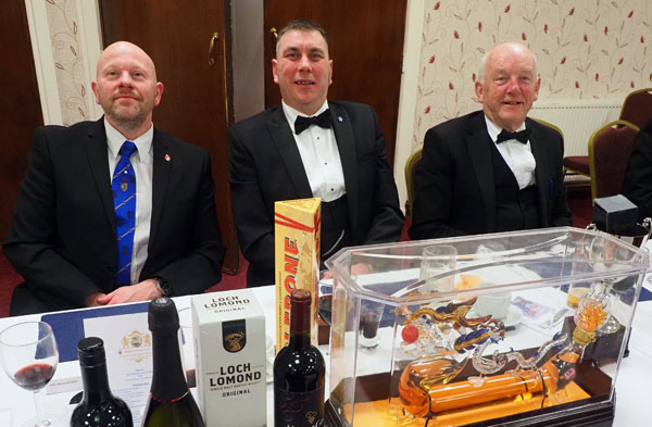 Pictured, from left to right, are: Malcolm Bell, Matthew Brady and Stephen Kerrigan, with the raffle prizes lined in front of them.