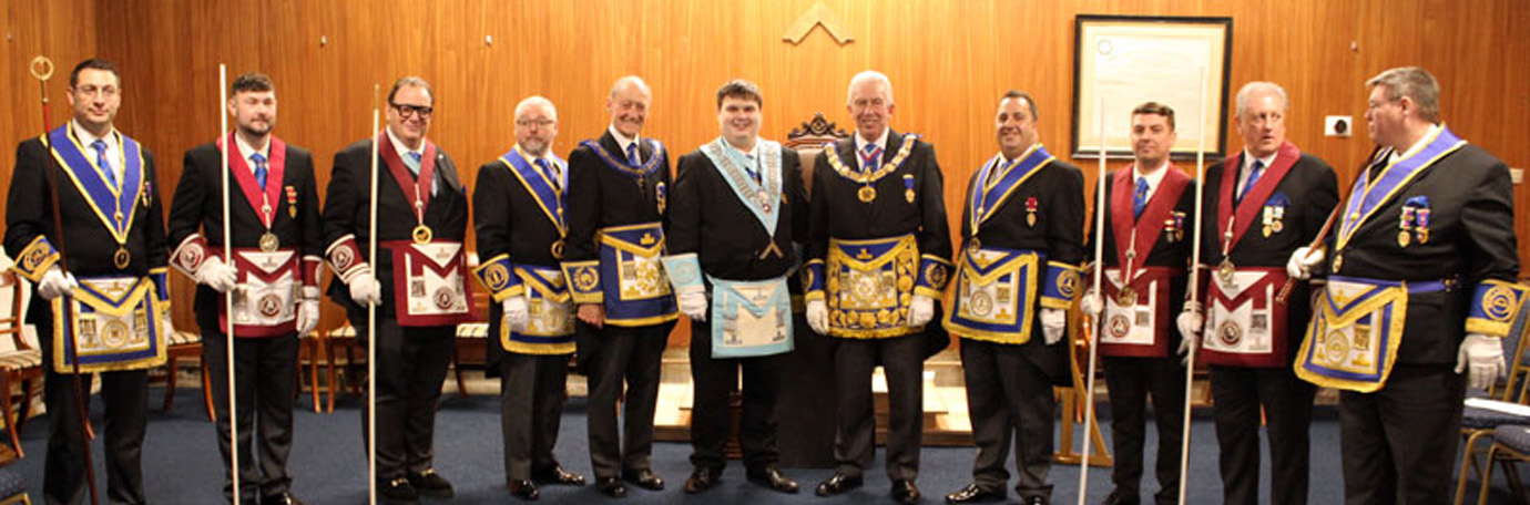 Pictured central from left to right, are: AProvGM Barry Jameson, Sam Wood and Mark Matthews with members of the Provincial team and acting Provincial grand officers.