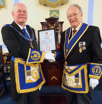 Duncan Smith (left) presents Tony Ansell with his 50th certificate.