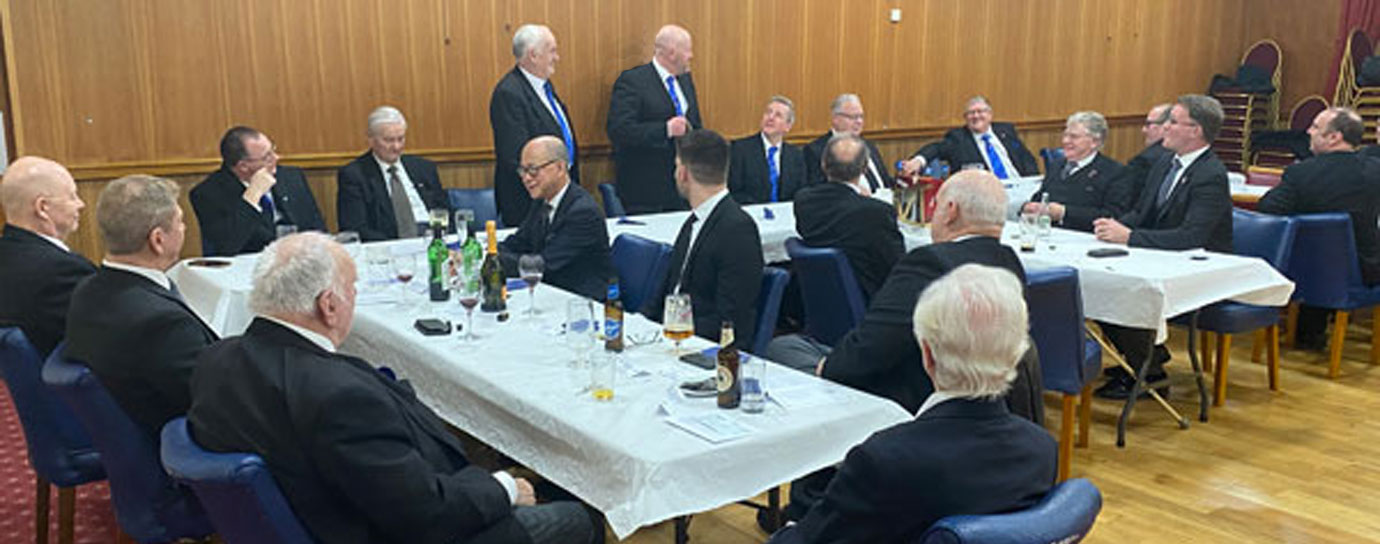 Malcolm (standing right) responding to his toast at the festive board.