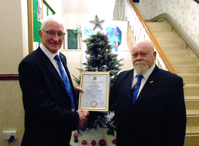 Bob Winch (left) with his certificate and Geoffrey Enright.