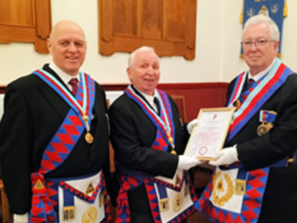 Pictured from left to right, are: David Atkinson, Ian Gillespie being presented with the certificate by John Murphy.