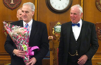 Andrew Whittle (left) is presented flowers for his wife by Ian Heyes.