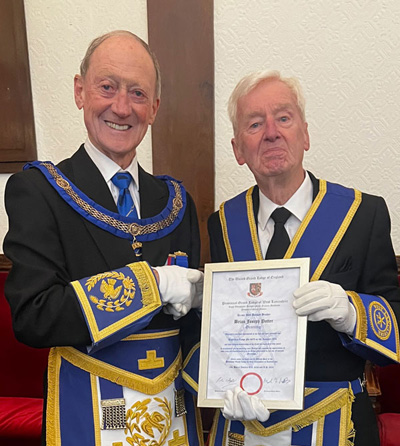 Barry Jameson (left) presenting Brian Potter with his 50th Certificate.