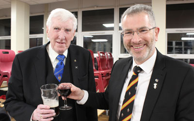Damien McKeand (right) and Glen Jackson relax with a drink at the festive board.