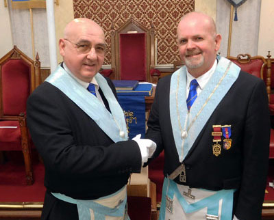 Ian Cottam (left) is congratulated by immediate past master Kevin Rigg.