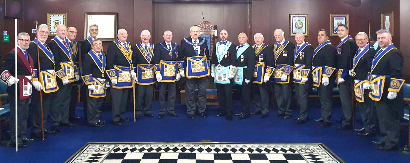 Philip Gunning and Keiron Griffiths surrounded by grand and acting Provincial grand officers.
