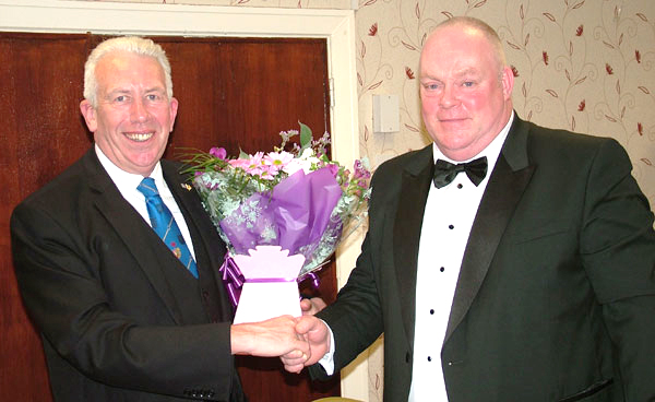 Joe Ayrton (right) presents Mark Matthews with flowers for his wife, Debbie.