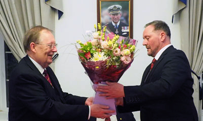 Colin Rowling (left) receives flowers for his wife from Neil MacSymons