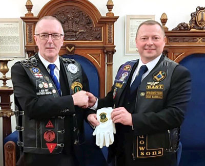 Ed presents the gloves to Tomas at Southport Masonic Hall.