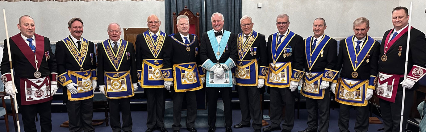 Pictured centre, are: Peter Schofield and David Makinson (in light blue) with other distinguished guests at the installation meeting.