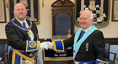 Malcolm Bell (left) congratulates the new master of the lodge William Worthington.