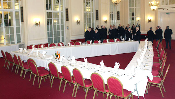 The guests assemble at the triangular table festive board.