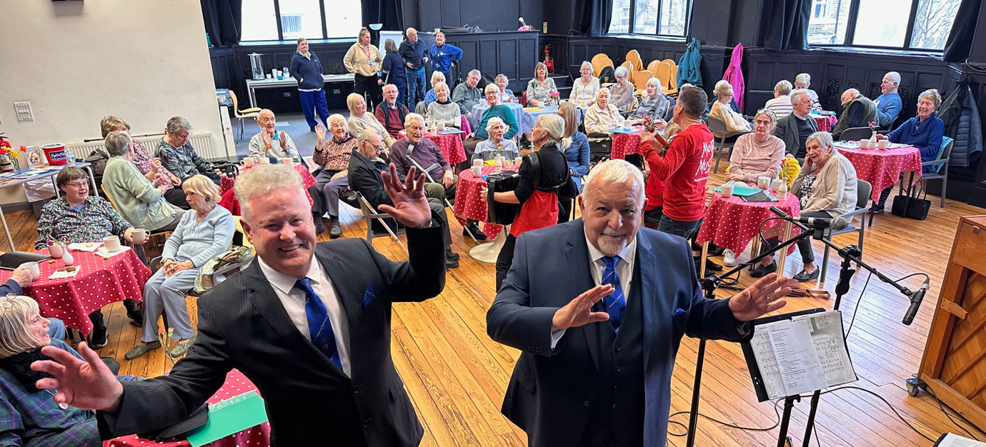 Peter Schofield and Barry Dickinson join in the singalong.