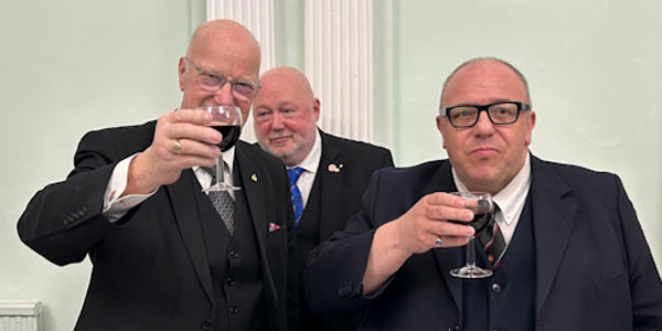 Stephen Walls (left) toasts the WM Graham Greenhall (right) under the watchful eye of Jason Hengler.