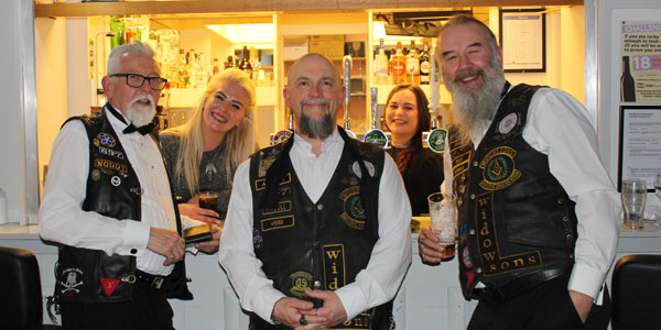 Pictured from left to right, are: Members of Widows Sons, Mal Kidd, Mark Denton and Andy Baxendale enjoying a drink at the bar with two of the bar maids.