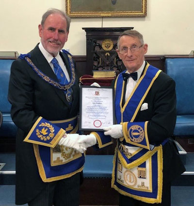 Roy receives his certificate from Frank Umbers.