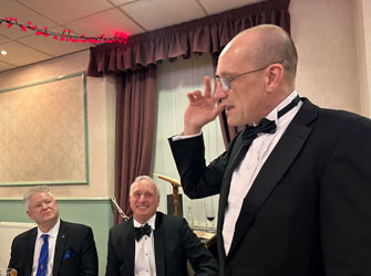 Installing master Richard Tebb proposes the toast to the incoming WM, with David Makinson (centre) and Peter Schofield, both seated, looking on