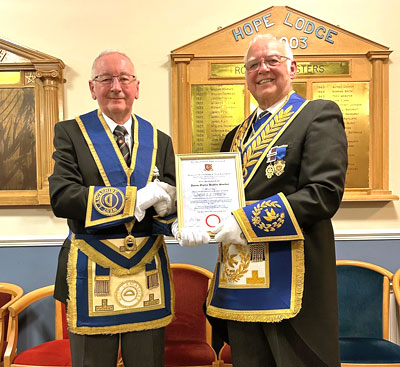 David (right) presents Martin with his celebratory certificate.