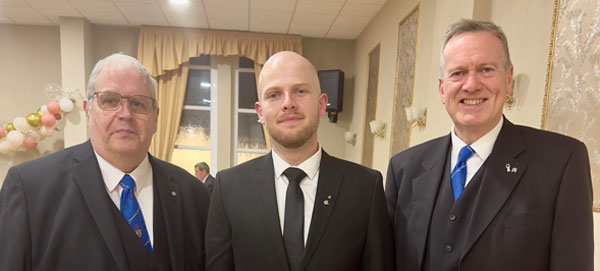 Neil Ward (left) and Nigel Monks (right) welcoming a new member at Euxton Lodge No 7192.