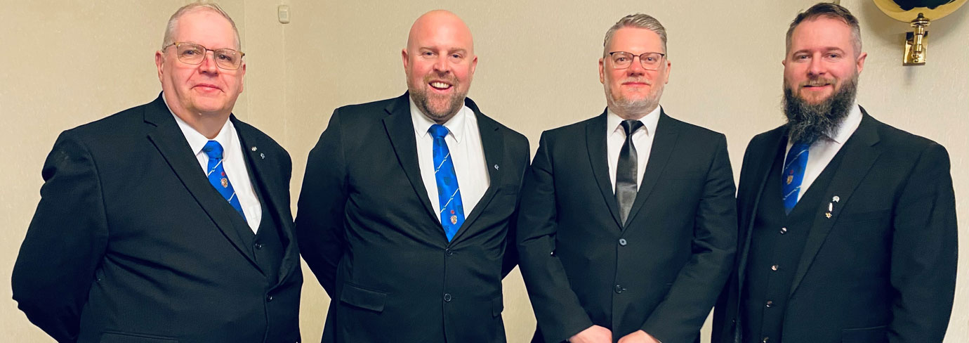 Pictured from left to right, are: Neil Ward, Chris Upton, welcoming a new member at Carnarvon Lodge No 2376. with Kieran Taylor-Bradshaw.