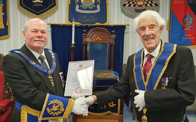 Duncan Smith (left) presents Neil Scott with his certificate celebrating 50 years in the Craft