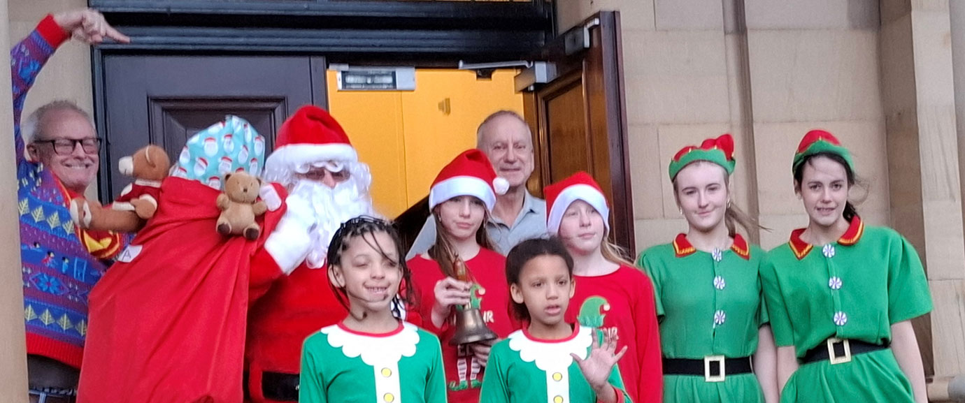 Santa tries to sneak into the hall with his elves and the Group Vice Chairman Brian Griffiths, as Southport Group Chairman Phil Stock (left) fails to contain his excitement. Santa tries to sneak into the hall with his elves and the Group Vice Chairman Brian Griffiths, as Southport Group Chairman Phil Stock (left) fails to contain his excitement.