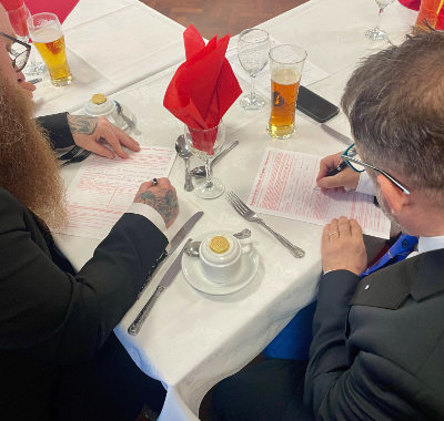 The candidates complete their application forms before dinner is served. The candidates complete their application forms before dinner is served.