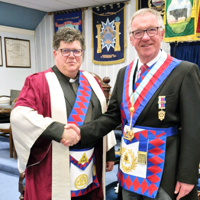 Reverend John Hall (left), congratulated by John Robbie Porter. Reverend John Hall (left), congratulated by John Robbie Porter.