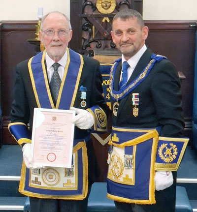 Cliff Davies holds his certificate with clear pride, accompanied by David Thomas. Cliff Davies holds his certificate with clear pride, accompanied by David Thomas.
