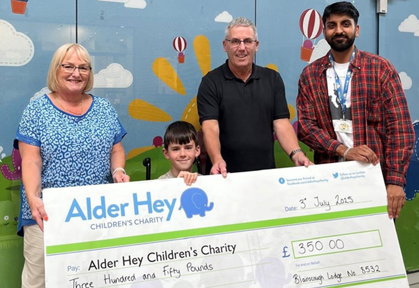 Pictured from left to right, are: Elaine Corner, Archie and Stephen Corner hand over the cheque to one of the many Alder Hey Charity members. Pictured from left to right, are: Elaine Corner, Archie and Stephen Corner hand over the cheque to one of the many Alder Hey Charity members.