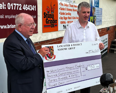Harry Cox (left) receiving the cheque from Chris Larder. Harry Cox (left) receiving the cheque from Chris Larder.
